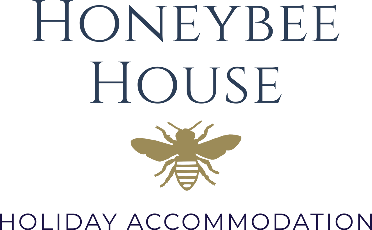 Logo for Honeybee House Holiday Accommodation featuring a stylized bee.