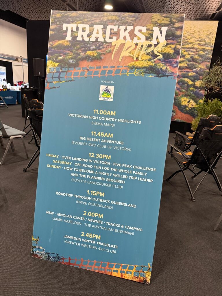 A large event schedule board lists 