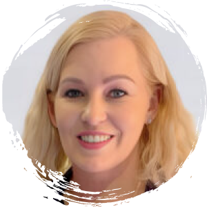 Portrait photo of a woman with shoulder-length blonde hair, light skin, and a friendly smile, set against a light background with a circular white border.