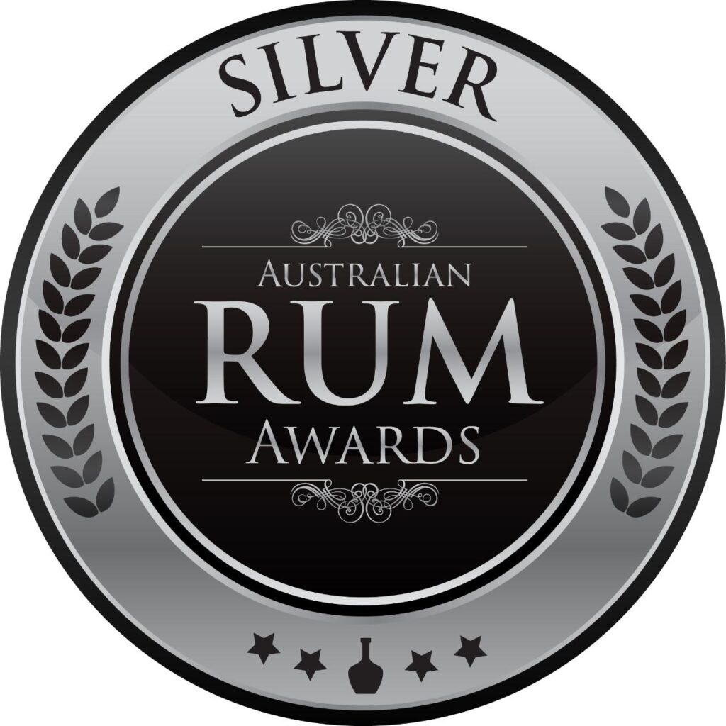 Silver medal badge for the Australian Rum Awards, featuring laurel leaves and decorative text on a black and silver circular design.