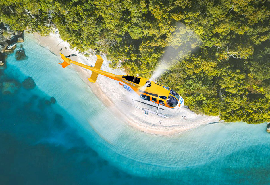 A yellow helicopter flies above a secluded beach surrounded by turquoise water and dense green forest.